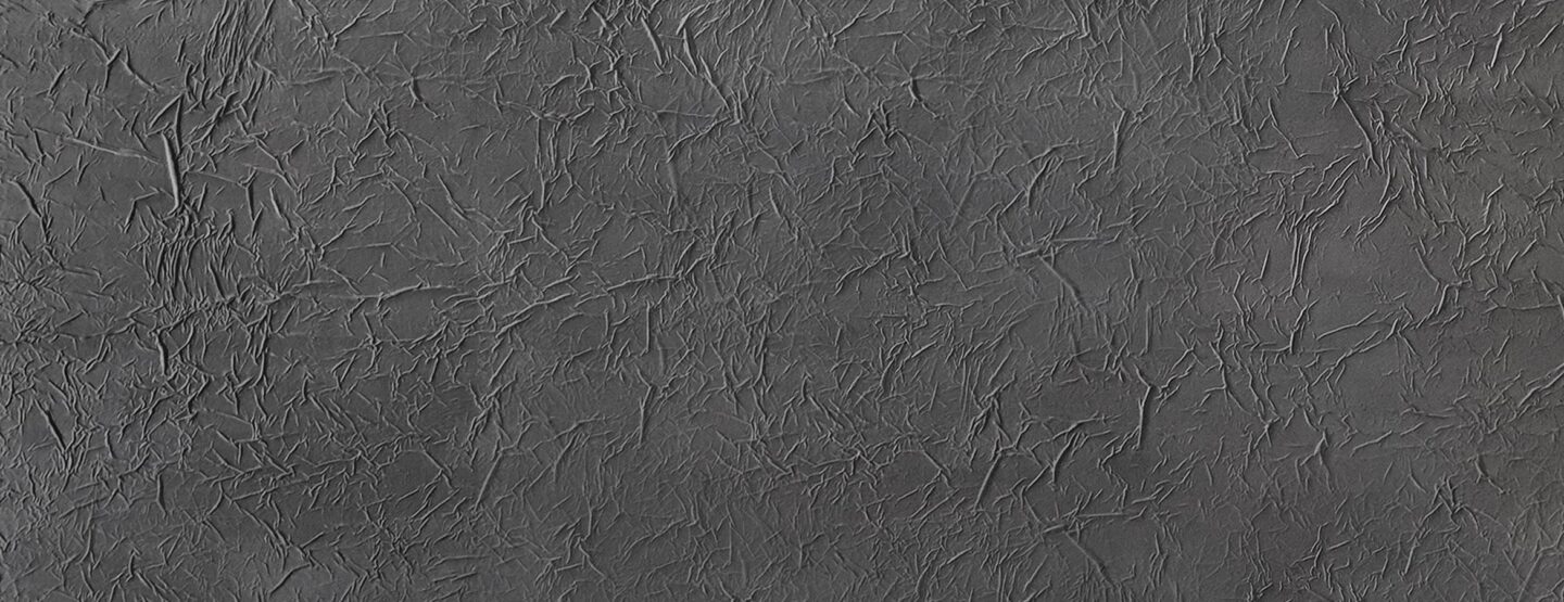 Ganzplattenfoto einer grauen strukturierten Designplatte im Samtlook