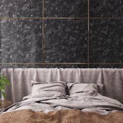 Bed back wall with square black marble elements separated by golden profiles