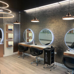 Modern hair salon with textured gray wall panels