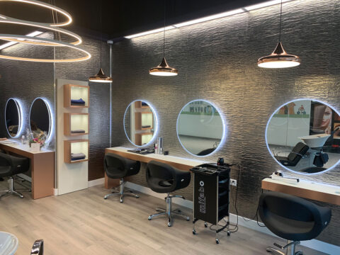 Modern hair salon with textured gray wall panels