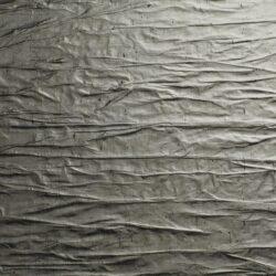 Detail of a gray matte and textured surface in a crinkled look