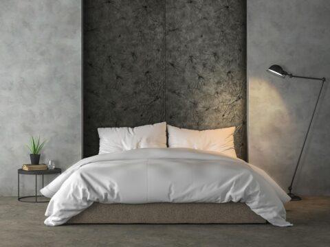 Bed back wall with black textured decorative panels in lotus leaf look