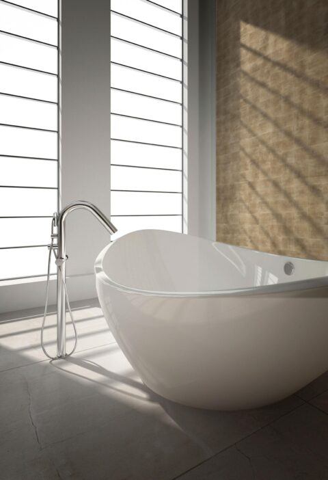 Freestanding bathtub with back wall in gold patterned decor