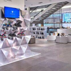 Modern shoe store with 3D shaped presentation shelves in mirror look