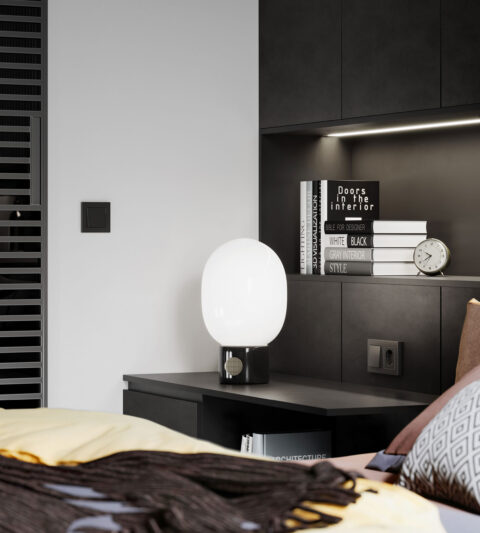 Detail of nightstand in black and books on a shelf with black lining