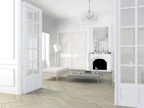 Bright modern living room with white furniture and white patterned wall elements