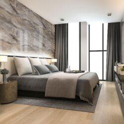 Classy hotel room in beige tones with a high gloss marble design bed back wall