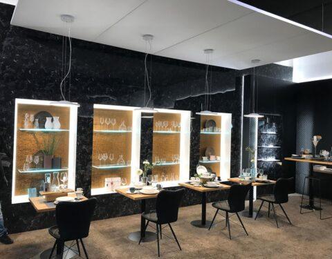 Modern restaurant with dark interior and golden niches