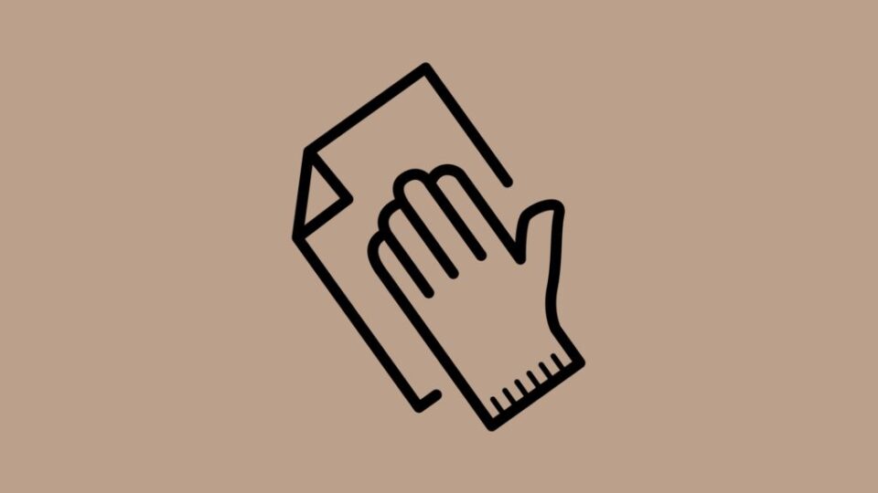 Hand mit Tuch Symbol in schwarz auf beigem Hintergrund