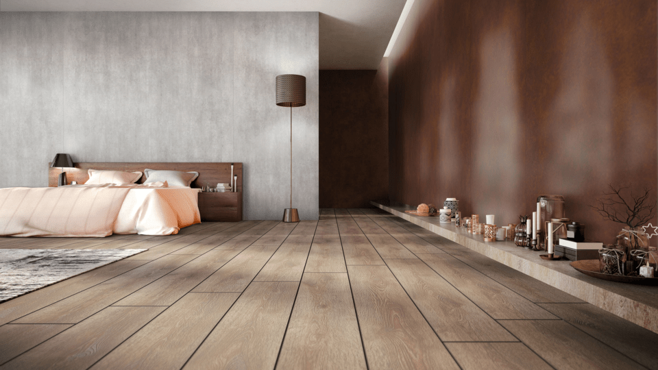 Bedroom with dark wooden floor and a wall with panels in reddish wood look