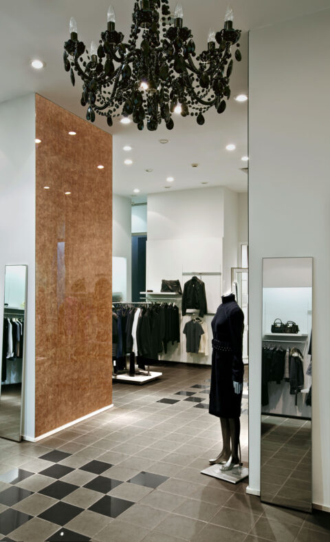 Modern shop with copper-coloured high-gloss wall panelling
