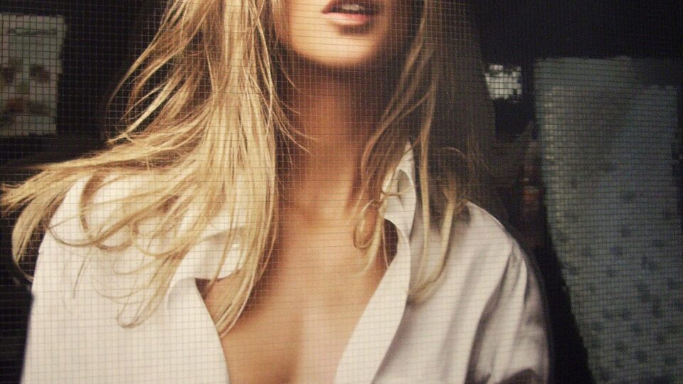 Young blonde woman as print on a black decorative plate