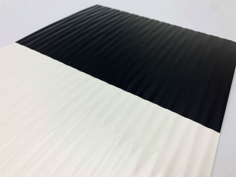 Detail of a white high gloss textured surface in wave structure