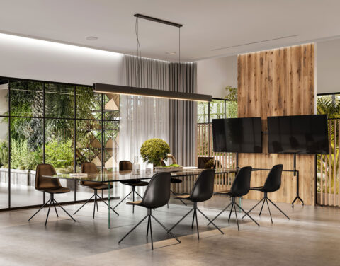 Modern meeting room in industrial lookl combined with wooden panels behind TV