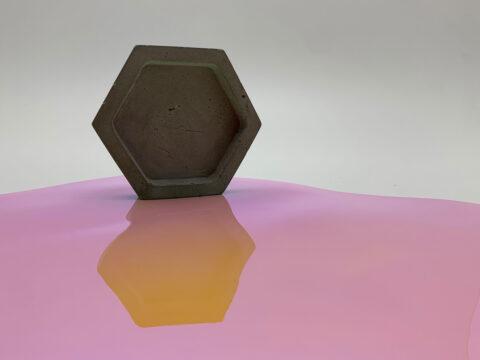 Wabe stehend auf rosa, glänzendem Dekor