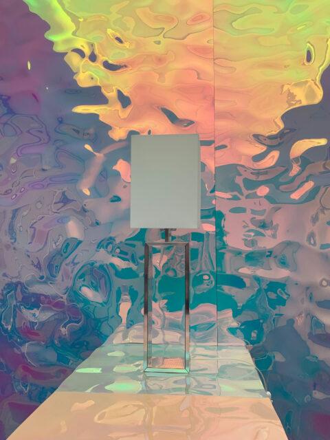 Table lamp, shimmering shades of pink and blue in the background