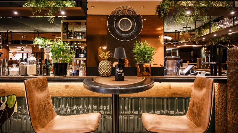 Copper-coloured mirror in the modern bar area on the wall