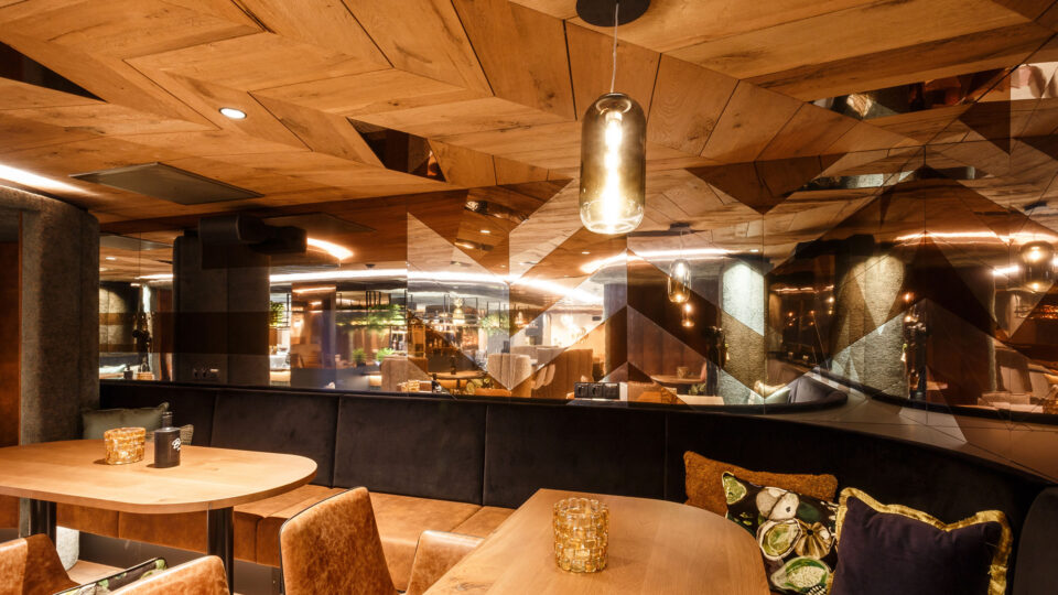 Copper-coloured mirror in the modern bar area on the wall