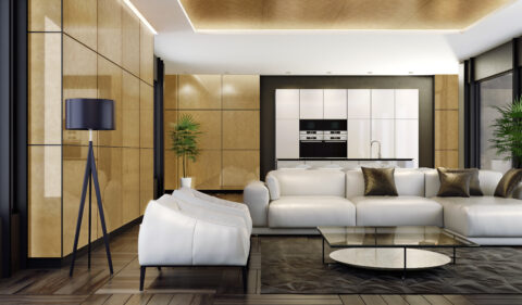 Modern kitchen/living area with reflective, golden fronts