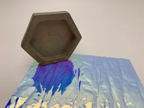 Close-up of a glossy, pink / blue decor with texture and honeycomb