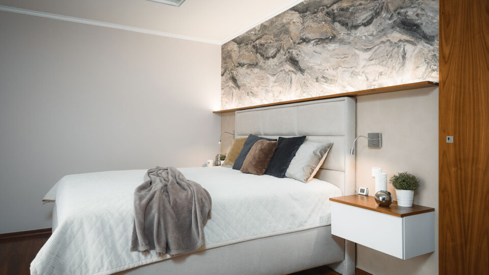 Bright bedroom with marbled wall on the left-hand side
