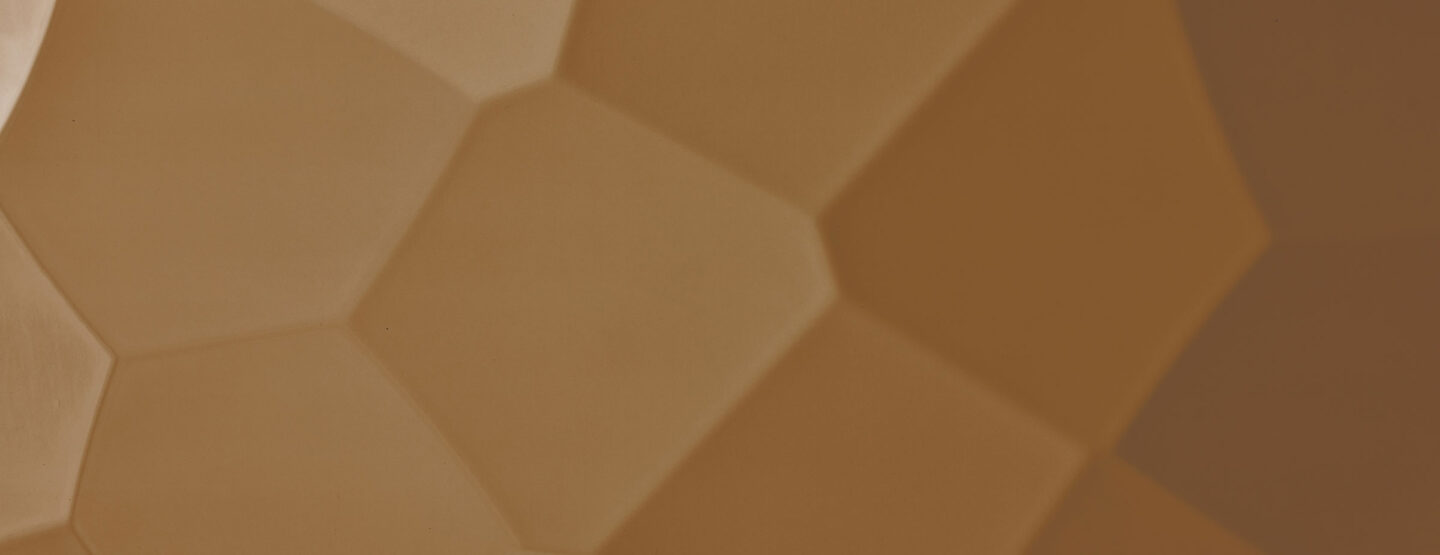 Detailed shot of a design panel whose structure is reminiscent of a hammer blow, the color is red-brownish and the surface is shiny and reflective.