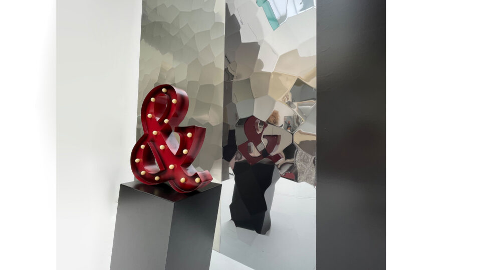 Shop window in the background silver and green metallic panels, texture like hammer blows.