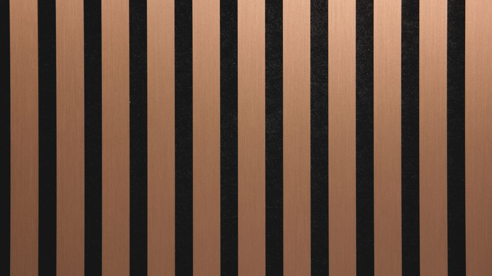 Detailed shot of a sound-absorbing acoustic panel. The surface is black and features elegant, brushed copper stripes.