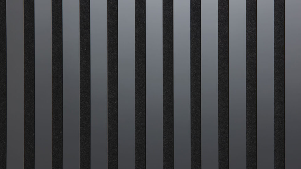 Detailed shot of a sound-absorbing acoustic panel. The surface is black and features elegant, reflective grayish stripes.