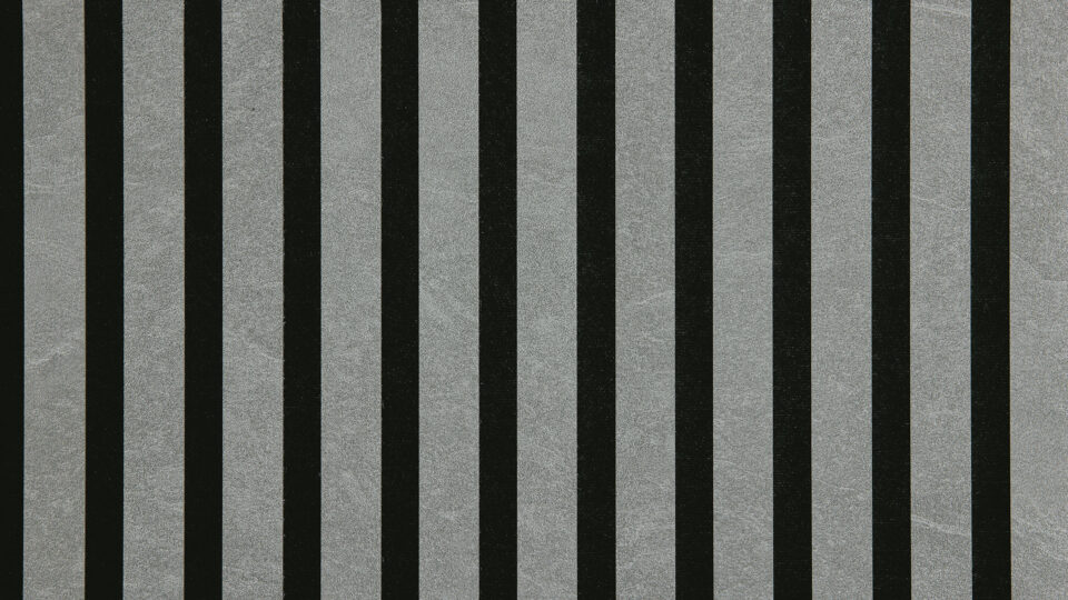 Detailed shot of a sound-absorbing acoustic panel. The surface is black and features elegant, gray, stone-colored stripes.