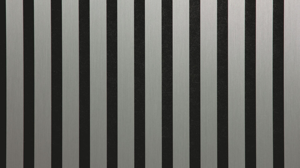 Detailed shot of a sound-absorbing acoustic panel. The surface is black and features elegant, metallic green stripes with a brushed look.