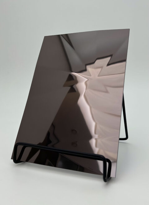 Dipslay stand with an anthracite reflective design panel whose structure is reminiscent of diamonds.