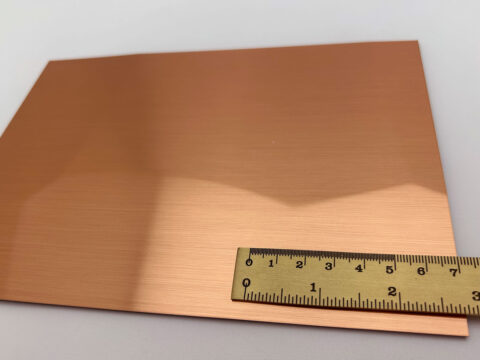 Detailed shot of the SL FACET Copper brushed design panel with a ruler