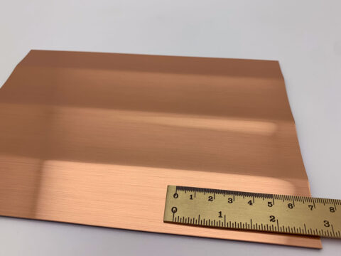 Detailed shot of the SL PILLAR Copper brushed design panel with a ruler