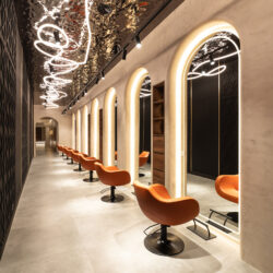 Treatment area of a beauty salon with a dark reflective ceiling.