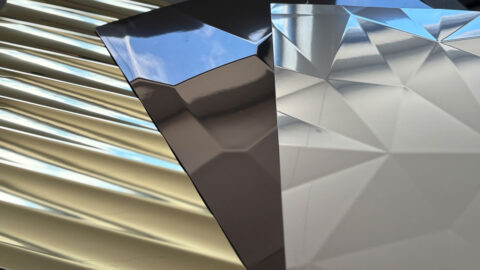 Three structured, reflective product patterns by SIBU DESIGN: the first in light gold with a modern interpretation of antique vertical columns, the second in anthracite resembling a hammered surface, and the third in silver reminiscent of a diamond cut.