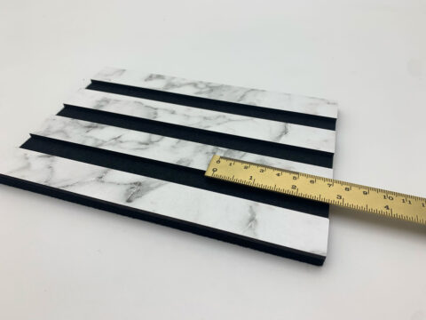 Close-up shot with ruler of the ACOUSTIC WALL PANEL AP in the colour MARBLE White