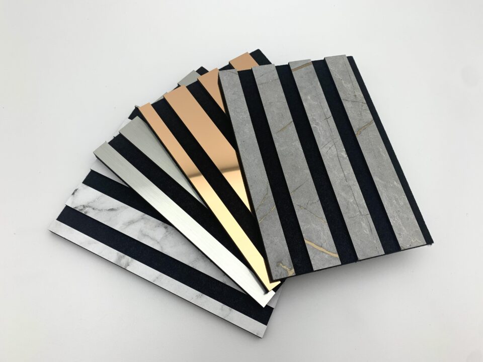 Acoustic panels fanned out on a white table, showcasing stylish and varied material combinations.